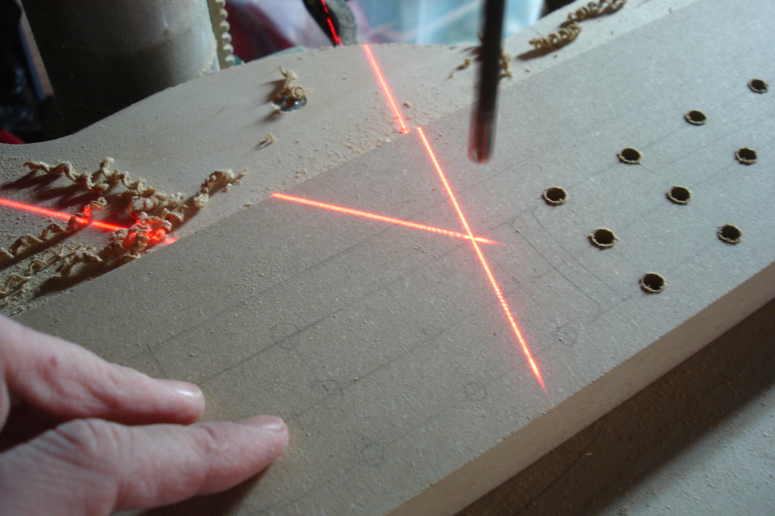 The laser cross is very helpful when it comes to drilling many holes fast - it indicates exactly where the center of the drill bit will cut into the wood.